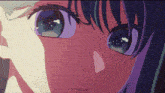 a close up of a girl 's face with purple hair