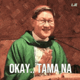 a man in a green robe with the words okay tama na written on it
