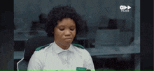 a woman in a white shirt with a name tag that says charles