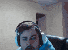 a man with a beard wearing headphones is sitting in a chair