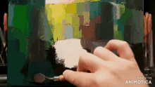 a person is painting on a canvas with the words made in animatica visible