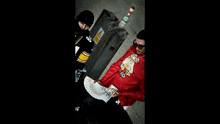 a man in a red sweatshirt with a duck on it