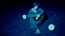 a man in a blue sweatshirt is looking up at the sky