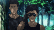 a man looking through binoculars with another man behind him