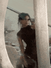 a woman is taking a selfie in front of a large mirror .