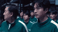 a man in a green jacket with the number 15 on the front