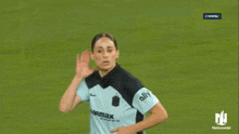 a female soccer player wearing a light blue carmax jersey