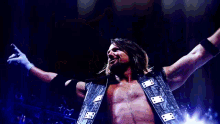 a wrestler wearing a red shirt that says the authority stands in a ring with his arms outstretched