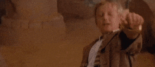 a man with blonde hair is standing next to another man in a room .