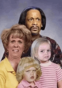 a family posing for a picture with their faces made up