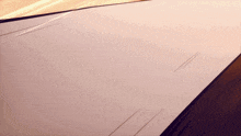a purple and gold background with a few lines going through it