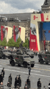 a military parade with a banner that says 1945 on it