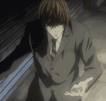 a man in a suit and tie is standing in the dark