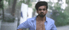 a man without a shirt is running down a street .