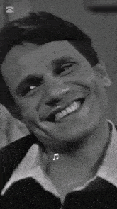 a black and white photo of a man smiling