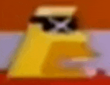 a blurred image of a yellow object with a black hat on it .