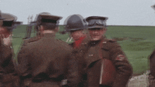 a group of soldiers are standing in a field and one of them has a patch on his jacket that says ao