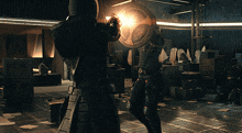 a man holding a shield and a gun in a dark room