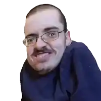 a man with glasses and a mustache is smiling and wearing a blue shirt