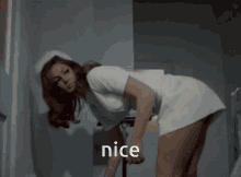 a woman in a nurse 's uniform is bending over and the word nice is on the bottom right