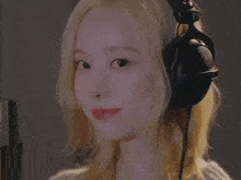 a woman with blonde hair is wearing headphones