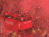 a red double decker bus that says champions on the side