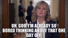 a woman is standing in a hallway and says oh god i 'm already so bored thinking about that one day off
