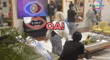 a group of people are standing in a living room in front of a television and a sign that says oa !