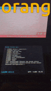 the word orang is on a screen next to a monitor