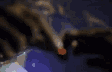 a person is smoking a cigarette with smoke coming out of it .