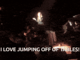 a woman jumping off of a table with the words i love jumping off of tables above her