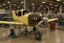 an airplane is being built in a warehouse with its engine exposed