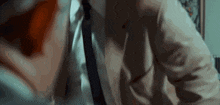 a man in a suit and tie is talking on a phone