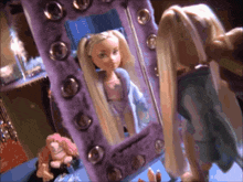 a doll is looking at her reflection in a mirror with a purple frame