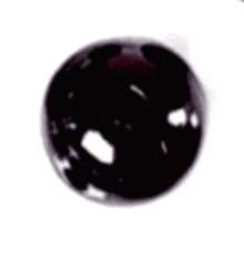 a close up of a glass of wine with a purple sphere in it .