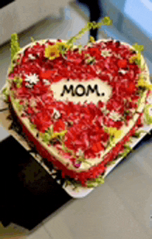 a heart shaped cake with the words mom on it