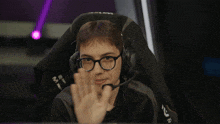a man wearing glasses and a headset with the word r on it