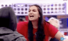 a woman in a red shirt is screaming at a man in a wheelchair .