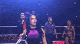 a woman with horns is holding a nxt championship