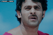 a close up of a man 's face with a blue sky in the background and a watermark that says pranay_varma