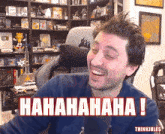 a man in a gaming chair is laughing with the words hahahaha written in red