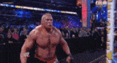 a wrestler with a red w on his arm stands in front of a crowd