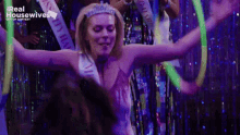 a woman wearing a sash that says ' miss ' on it is dancing