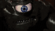 a close up of a monster 's face with a blue eye and braces .