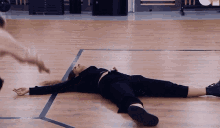 a woman laying on a wooden floor with her legs crossed