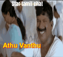 a man with a mustache is smiling in front of a woman in a blue dress and the words star tamil chat behind him