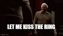 an older man is talking to another man in a dark room with the words `` now about the one in the center of my ass '' .