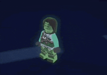 a person is standing in a dark room with a green glow coming out of their body .