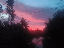 a pink and blue sunset over a river