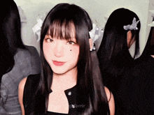 a girl with long black hair has a flower in her hair and the word aerie is on the bottom